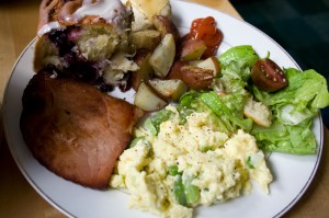 Scrambled eggs with asparagus & spring onions, green salad with radishes, cukes, and torn bread garlic croutons, fried Nueskes ham, rosemary-roasted potatoes, blueberry cinnamon rolls, baby biscuits