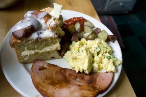 Scrambled eggs with asparagus & spring onions, green salad with radishes, cukes, and torn bread garlic croutons, fried Nueskes ham, rosemary-roasted potatoes, blueberry cinnamon rolls, baby biscuits