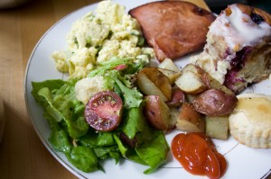 Scrambled eggs with asparagus & spring onions, green salad with radishes, cukes, and torn bread garlic croutons, fried Nueskes ham, rosemary-roasted potatoes, blueberry cinnamon rolls, baby biscuits