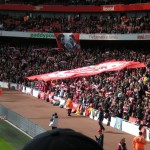 Fans holding up a flag to show their support for the team