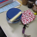 Packed lunch - containers are rice pudding & pear applesauce; scone in the reusable bag, string cheese 