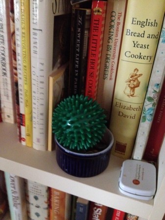 Green massage ball, on cookbook shelf - to keep it safe from cats