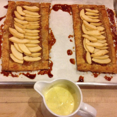Puff paste apple tarts with creme anglaise in bad light