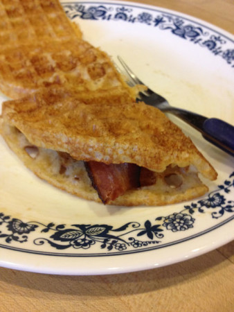 Waffles wrapped around bacon - the way I like to eat them - using fingers rather than fork, dunked in syrup