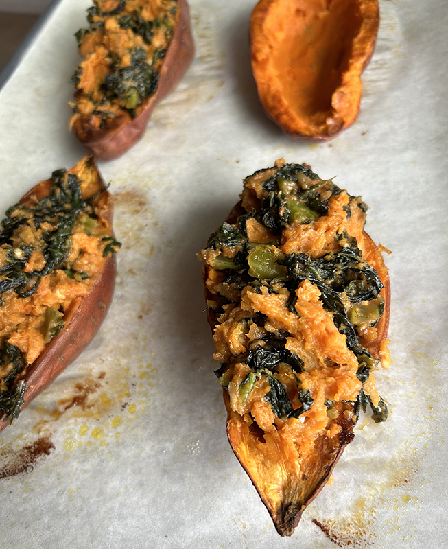 Sweet potatoes stuffed with greens and peanut sauce